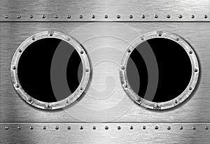 Two metal ship portholes