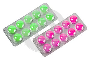 Two metallic blister with purple and green pills