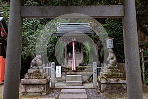 Two mice statues and shrine framed between torii gate on Otoyo Jinja shrine of Kyoto