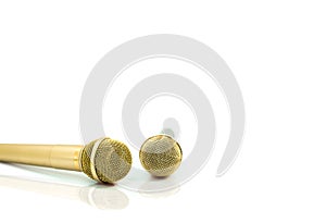 Two Microphone of gold on isolated white.