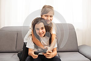 Two middle school girls at home playing an exciting video game together.