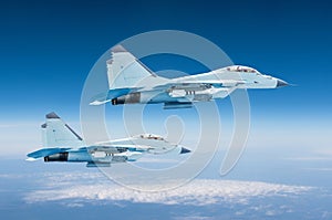 Two military fighters jet aircraft at high altitude, combat mission operation flying high in the sky.
