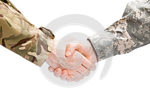 Two military men shaking hands on white background - close up studio shot