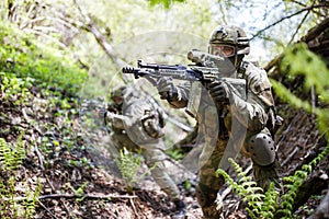 Two military people with machine-guns