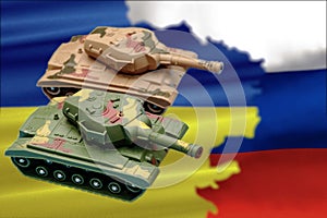 Two military tanks, a map with the flags of Ukraine and Russia.