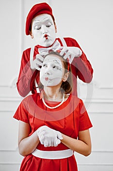 Two mime artists with face and hand makeup