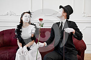 Two mime artists, love couple, scene with rose