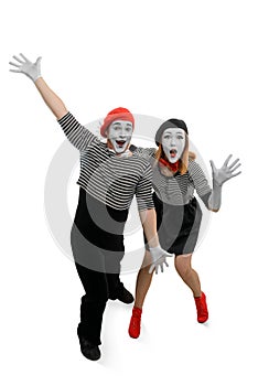 Two mimes are having fun. Vertical full length portrait of man and woman