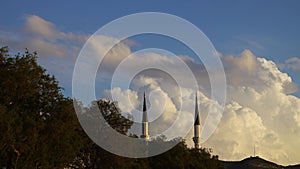 Two minarets on a background of blue morning sky. 4k timelapse.