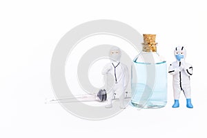 Two miniature doctor with ethyl alcohol in clear glass bottle with single-use syringe isolate on white background