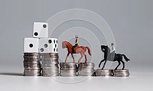 Two miniature men riding a horse with three white dice on coin stacks.