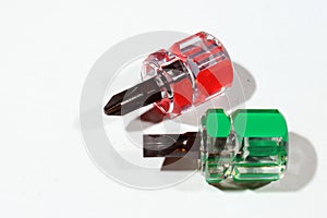 Two miniature screwdrivers on white background