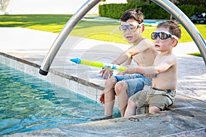 Two Mixed Race Chinese Caucasian Brothers By the Pool in Swimming Goggles