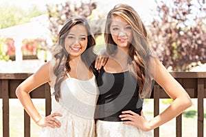 Two Mixed Race Teen Girlfriends Pose for Portrait Outdoors photo