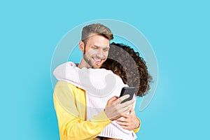 Two mixed race people standing on blue background