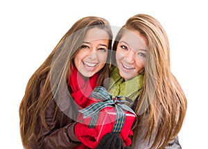 Two Mixed Race Teenaged Females Holding A Christmas Gift Isolated