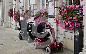 Two Mobility Scooters outside a Restaurant in London