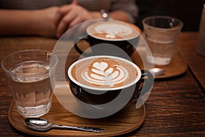 Two Mocha coffees with water served at a cafe photo