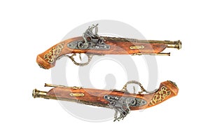 Two mock-ups of old vintage firearm pistols with bronze inlay isolated on a white background.