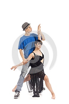 Two modern ballet dancers in dynamic action figure, on white background