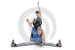 Two modern ballet dancers posing in studio.