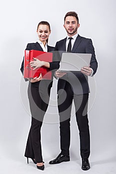 Two modern businessman standing on a white background with a lap