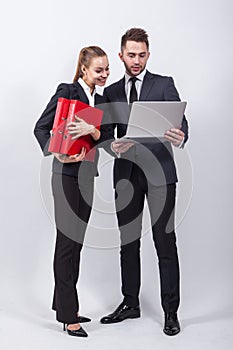 Two modern businessman standing on a white background with a lap