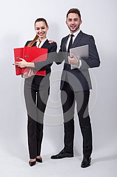 Two modern businessman standing on a white background with a lap