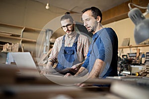 Two Modern Carpenters Working on Project