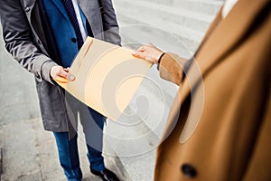 Two modern Caucasian business people standing outdoors