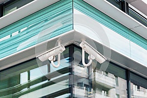 Two modern cctv security cameras on modern building facade