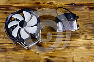 Two modern CPU coolers on wooden desk. Top view