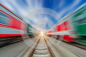 Two modern high speed train with motion blur under the blue sky