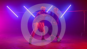 Couple performers making hiphop show in club. Two modern dancing street style.