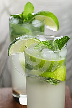 Two mojito cocktails on old oak table