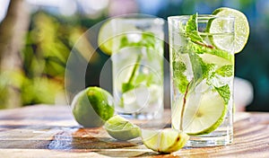 Two mojito cocktails on wooden table top