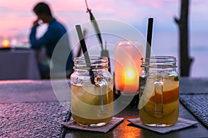 Two mojito jars and a lamp in a sunset