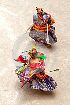 Two monks in a bull deity masks with ritual dagger phurpa perform religious Cham dance of Tibetan Vajrayana Buddhism