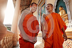 Two monks walk in a buddhist monastery, Asia photo