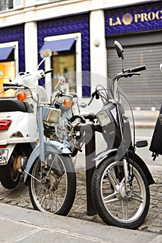 Two Mopeds Looking at Each Other Lovingly in Paris, France