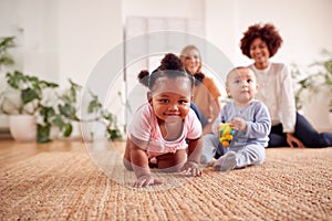 Two Mothers Meeting For Play Date With Babies At Home In Loft Apartment photo