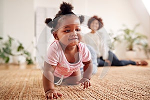 Two Mothers Meeting For Play Date With Babies At Home In Loft Apartment