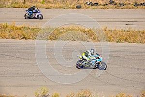 Two Motorcyclists Compete on Sunny Highway