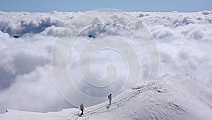 Two mountain climbers on an exposed ridge in the Swiss Alps