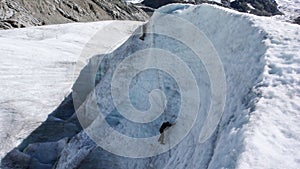 Two mountain guide candidates training ice axe and rope skills on a glacier in the Swiss Alps