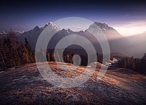 Two Mountain peaks with sunrays