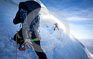 Two mountaineers climb steep glacier ice crevasse extreme sports, Mont Blanc du Tacul mountain, Chamonix France travel, Europe