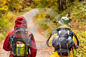 Two mountaineers hiking in autumn