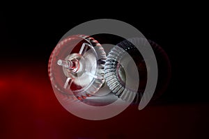 Two mouse scroller wheels on dark surface photo