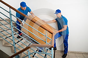 Two Movers With Box On Staircase